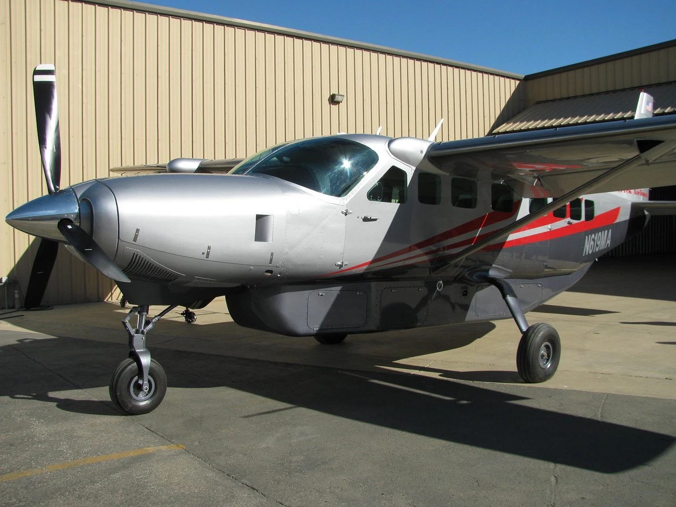 Silver and red Cessna Caravan photographed at Corona Air Paint